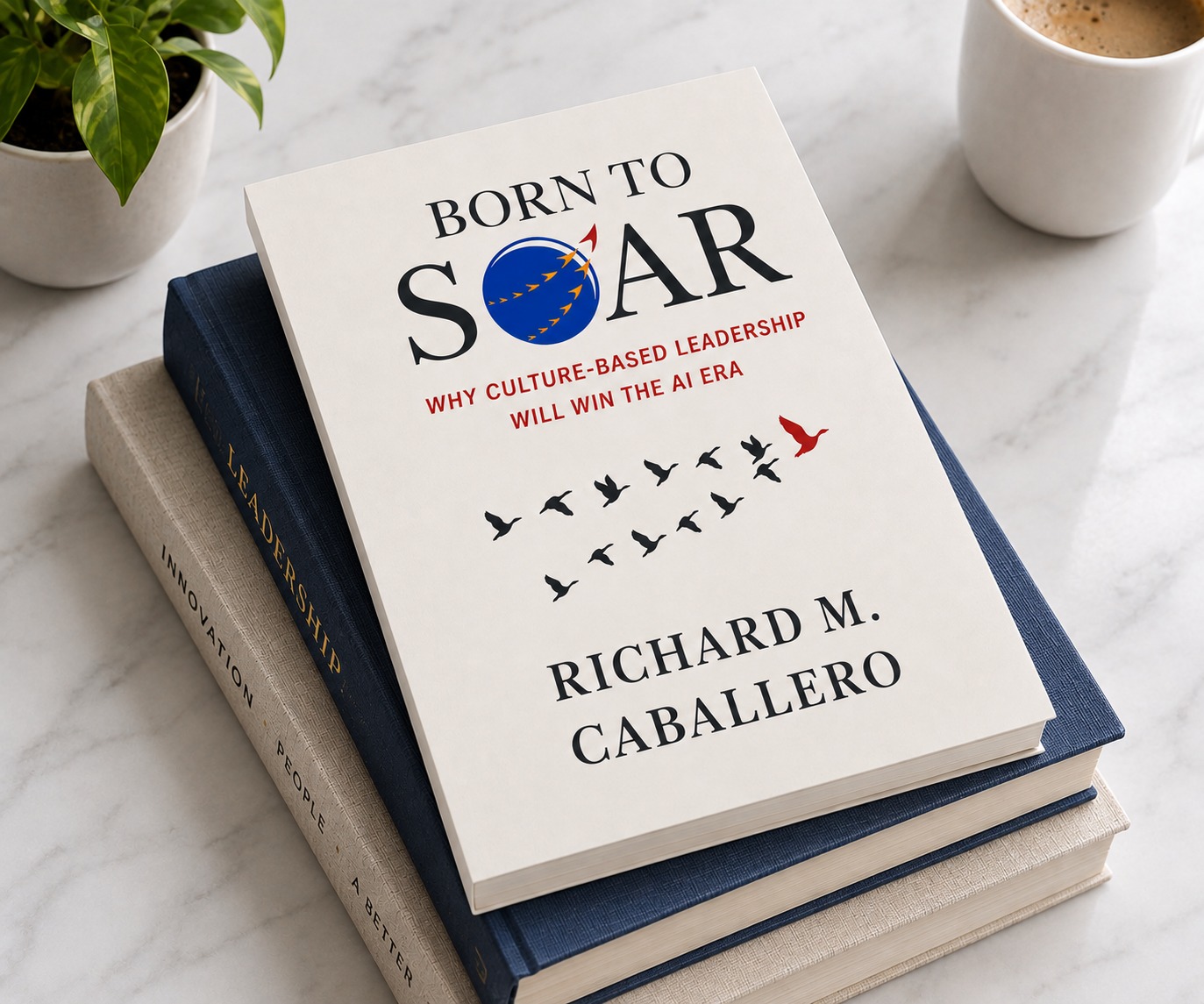 Born to Soar hardcover resting on a stack of books beside a potted plant