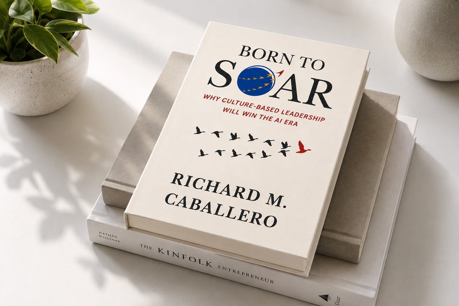 Born to Soar hardcover on a stack of books on a marble table with a cup of coffee