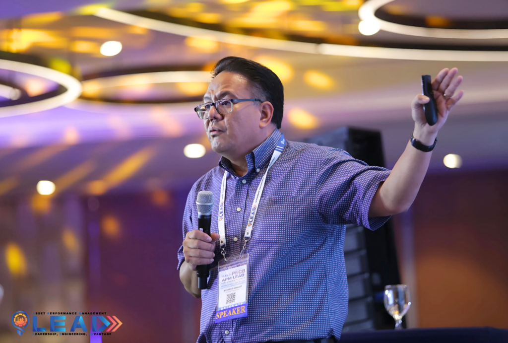 Richard Caballero speaking into a microphone at the APM LEAD 2024 conference
