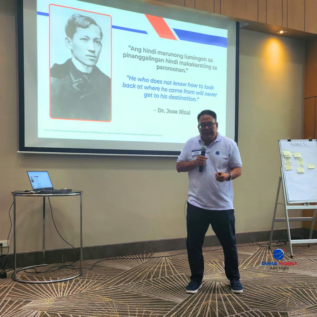 Richard Caballero presenting with a slide of a Jose Rizal quote about looking back at where you came from