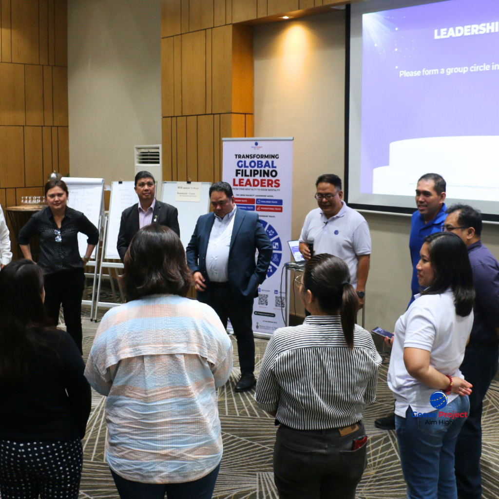 Workshop participants and facilitators standing in a circle during a group activity
